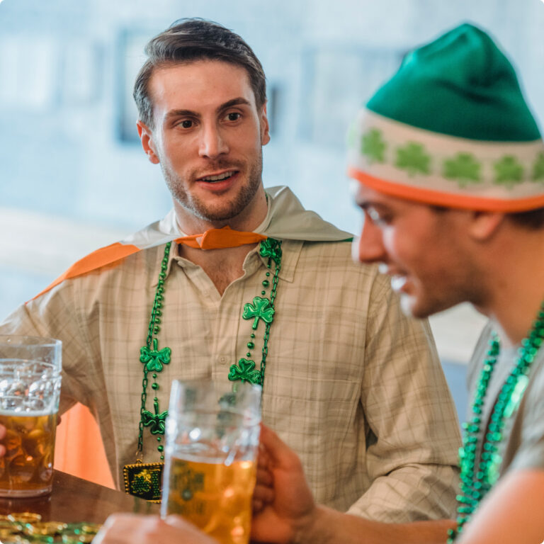 Two men celebrating St. Patrick's Day with steins of beer