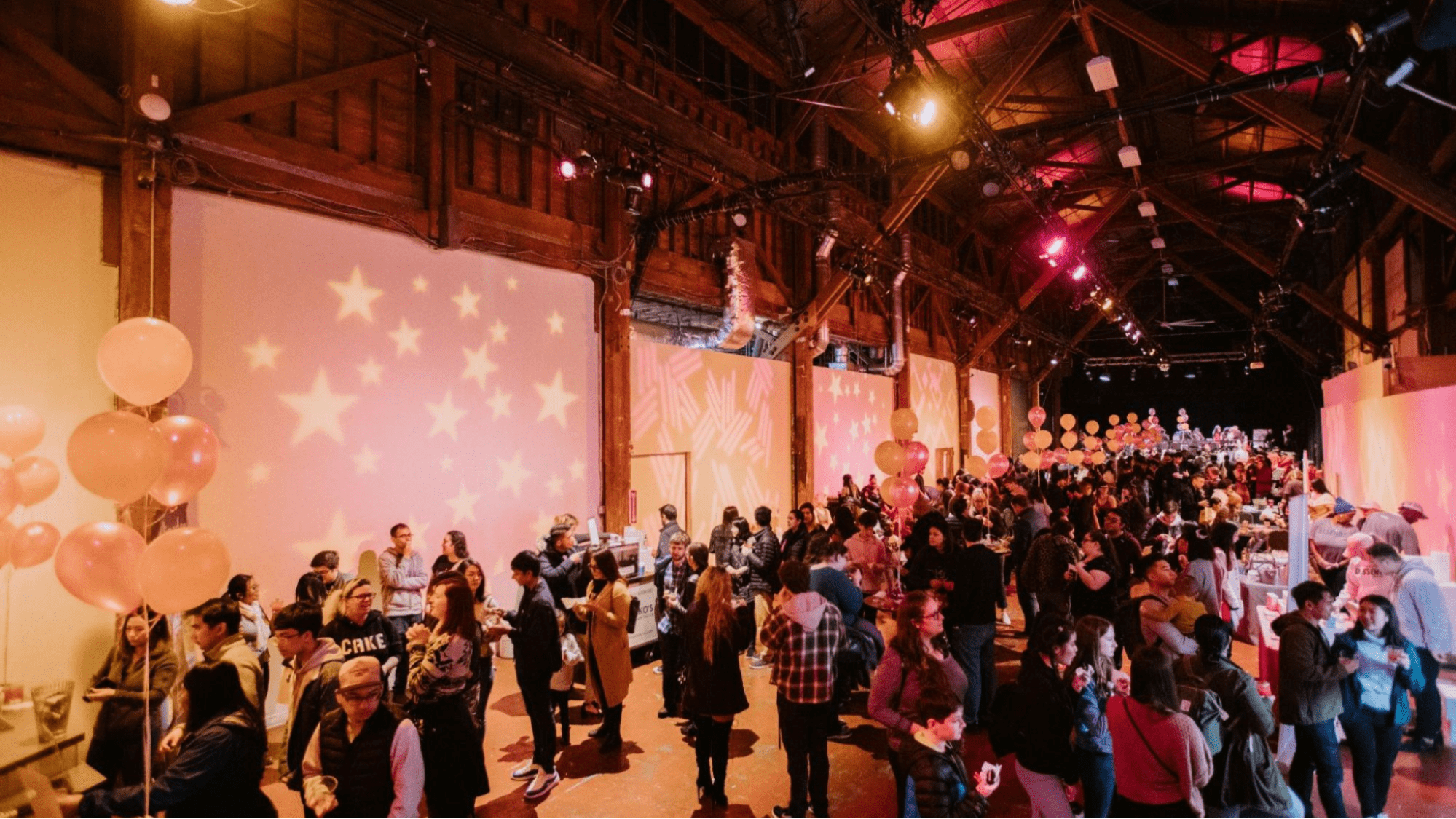 A crowd mingles at a food event